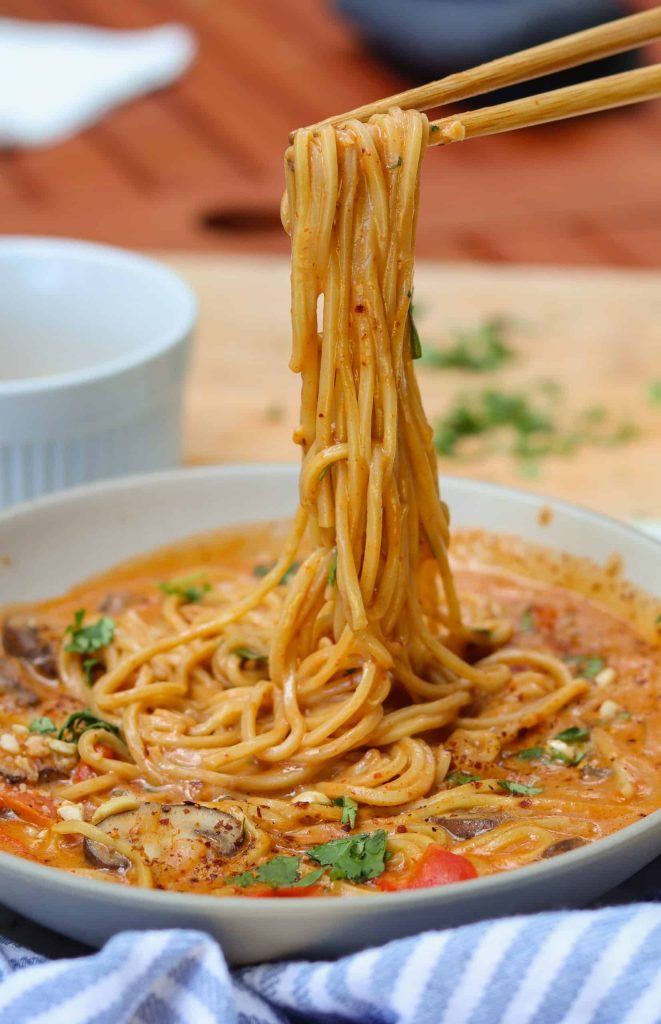 peanut ramen noodles in a white bowl.