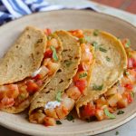 mexican potato tacos on a beige plate.