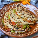 squash blossom quesadillas on a brown plate.