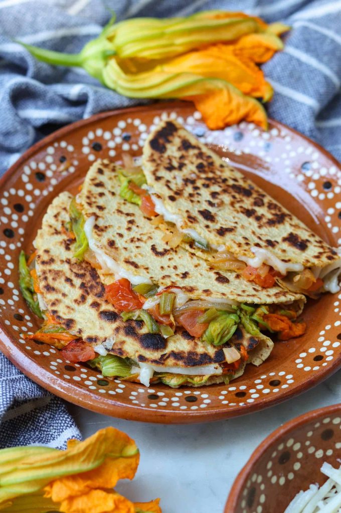 squash blossom quesadillas on a brown plate.