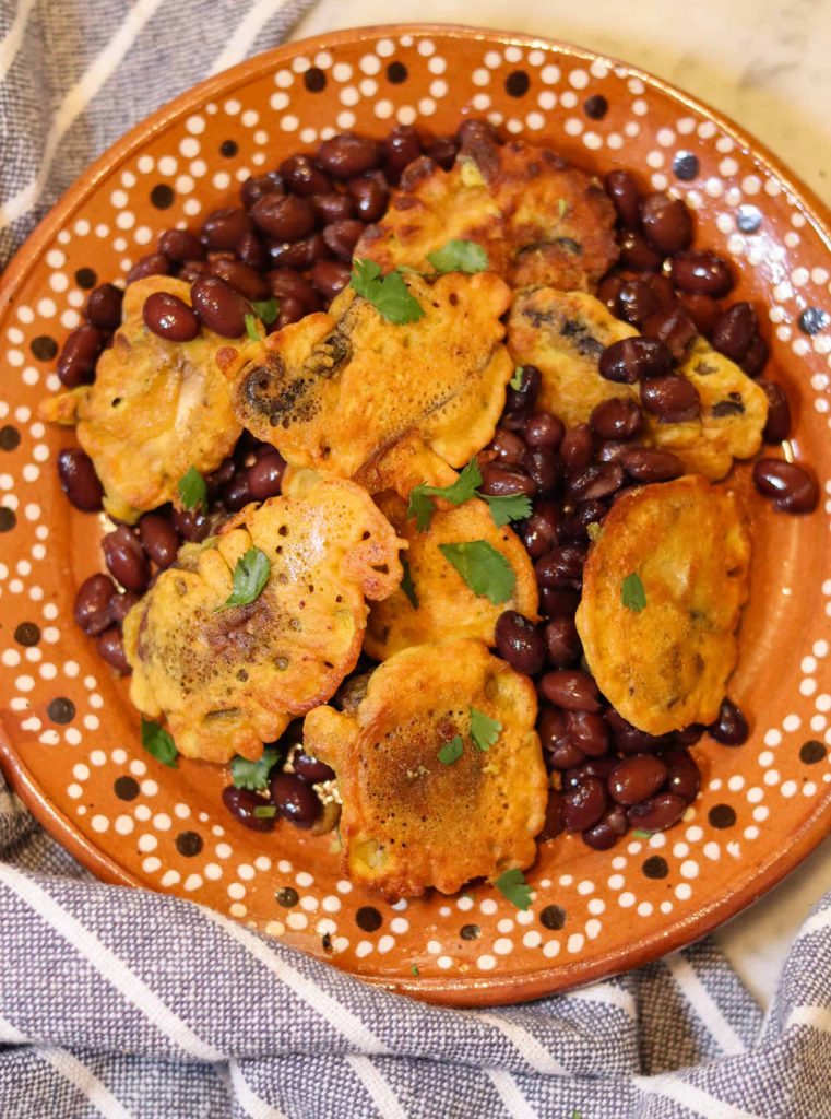 vegan tortitas de verduras on a plate with beans.