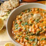 bean and kale soup in a bowl with crackers.